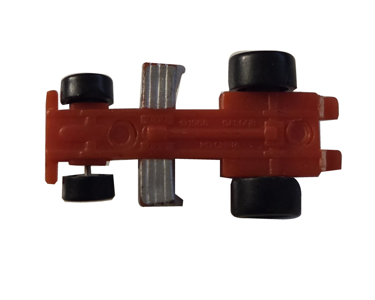 Preowned Galoob red racer chassis, incomplete on white background
