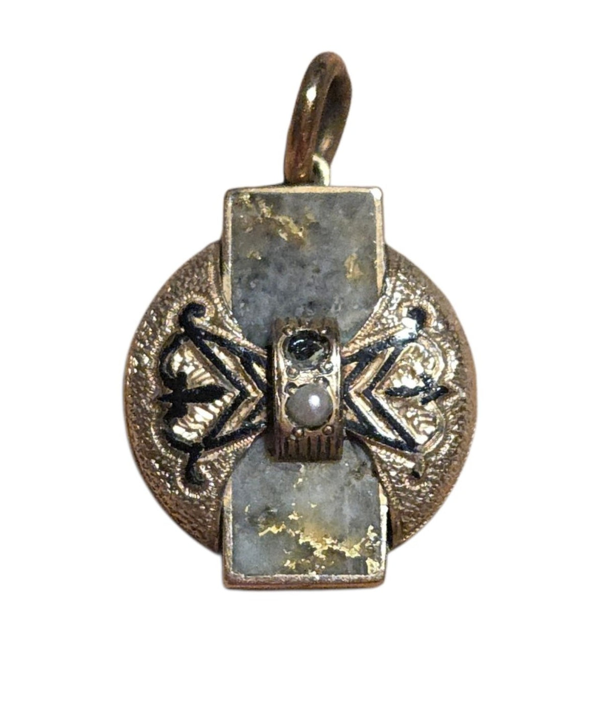 Front of vintage gold-tone pendant with black decorative accents and visible finish wear