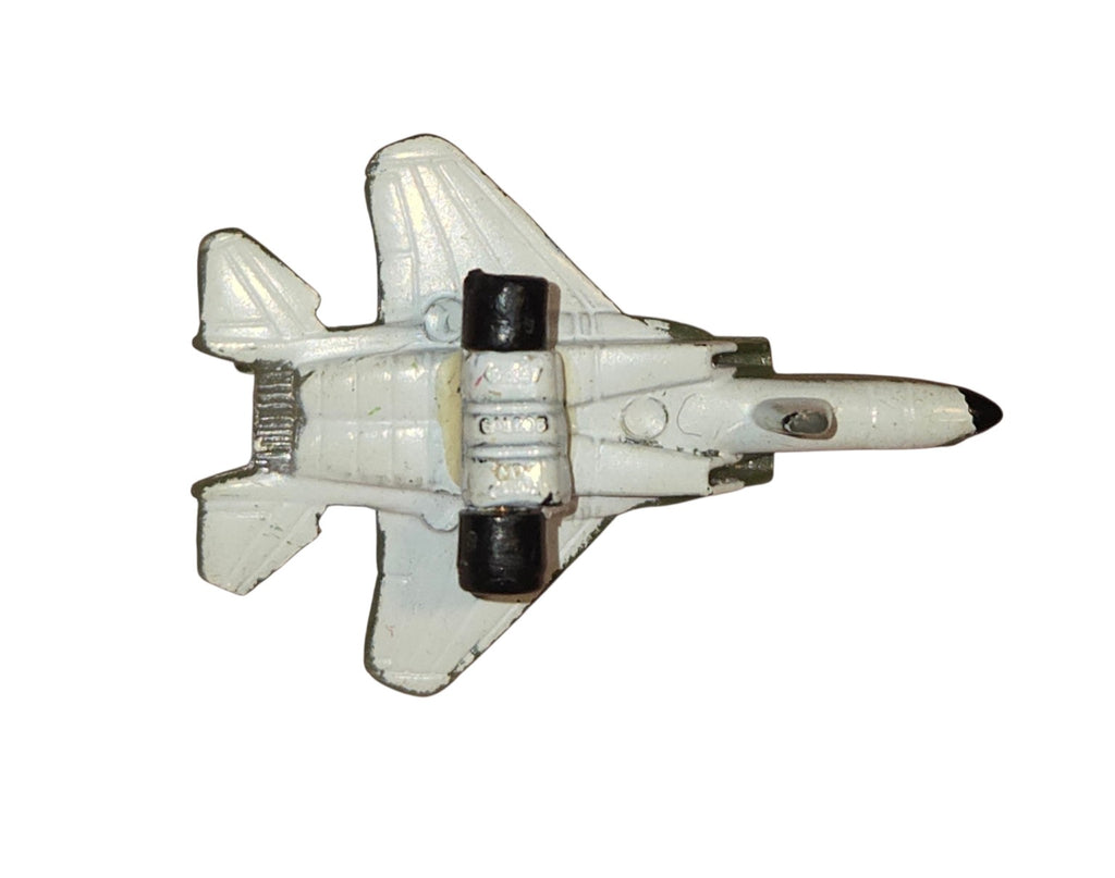 Miniature jet underside showing white paint wear and two black wheels