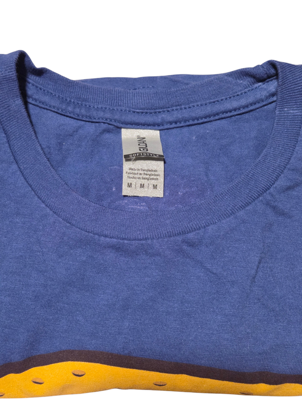 Gildan Softstyle Medium size tag on Stuffed Puffs blue T-shirt