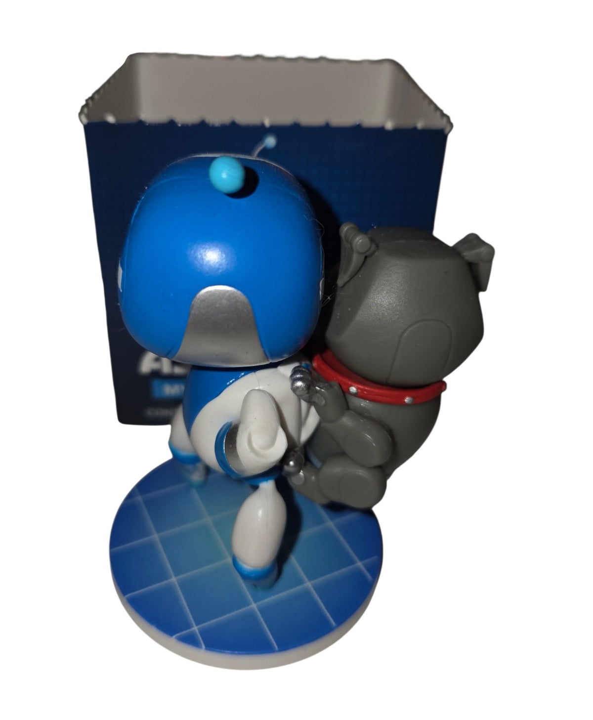 Rear view of Astro Bot carrying Barkster on blue grid base