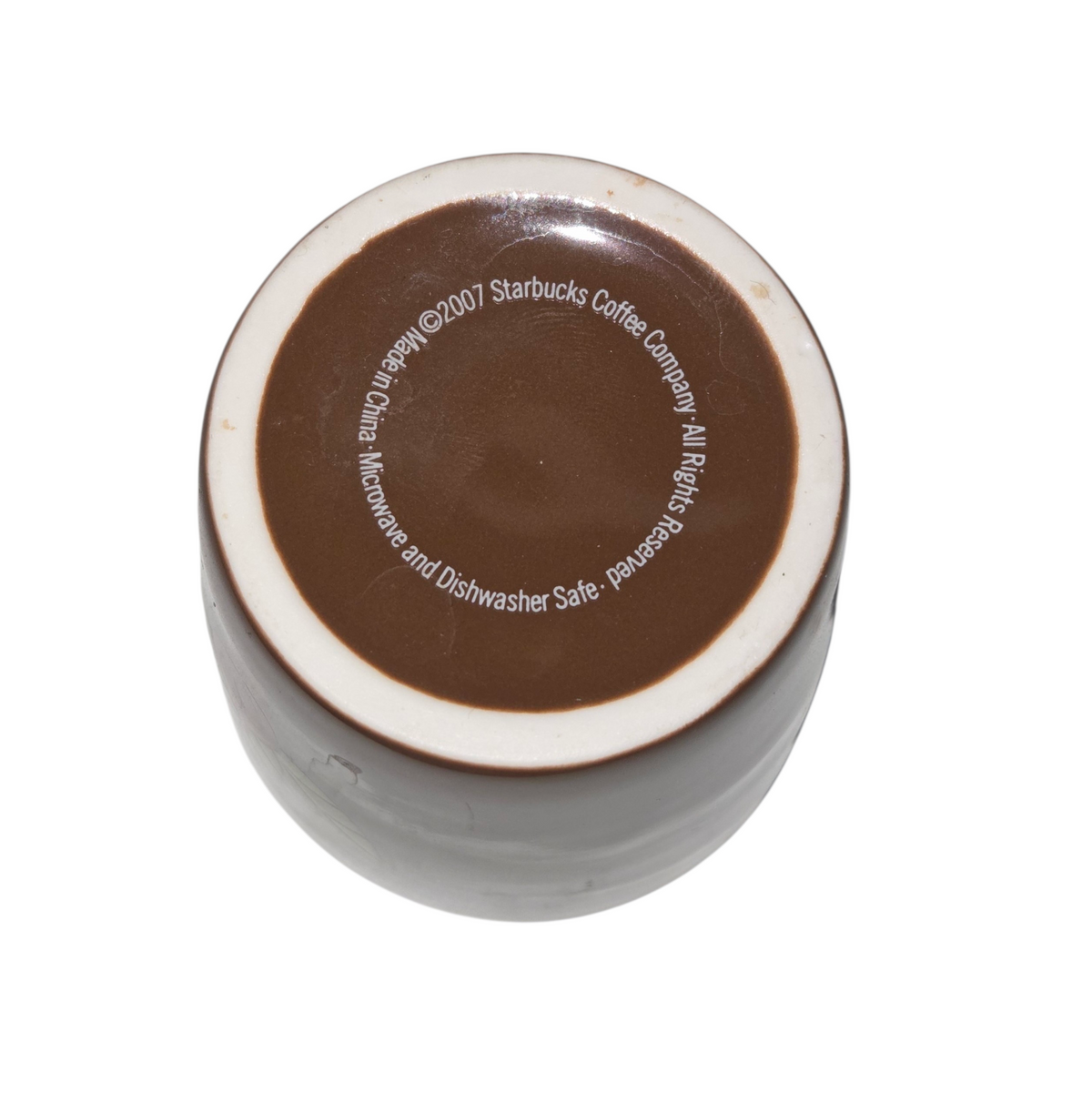 Starbucks cup base showing 2007 copyright, made in China and microwave dishwasher safe markings