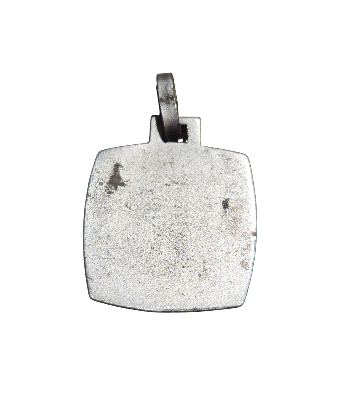 Reverse of vintage fish and loaves pendant showing wear and discoloration
