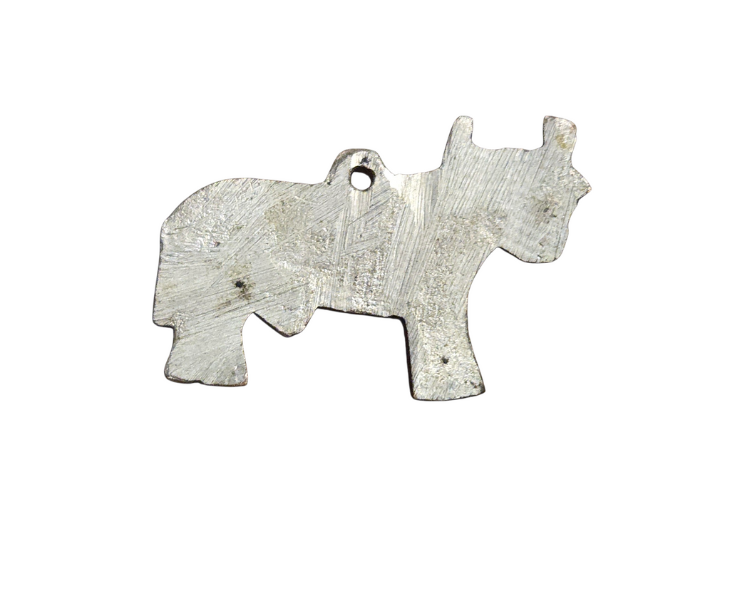 Flat reverse of silver-tone bull pendant showing scratches and dark spots
