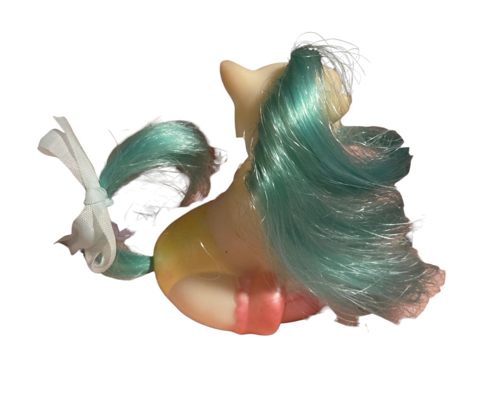 Rear view showing teal mane and tail
