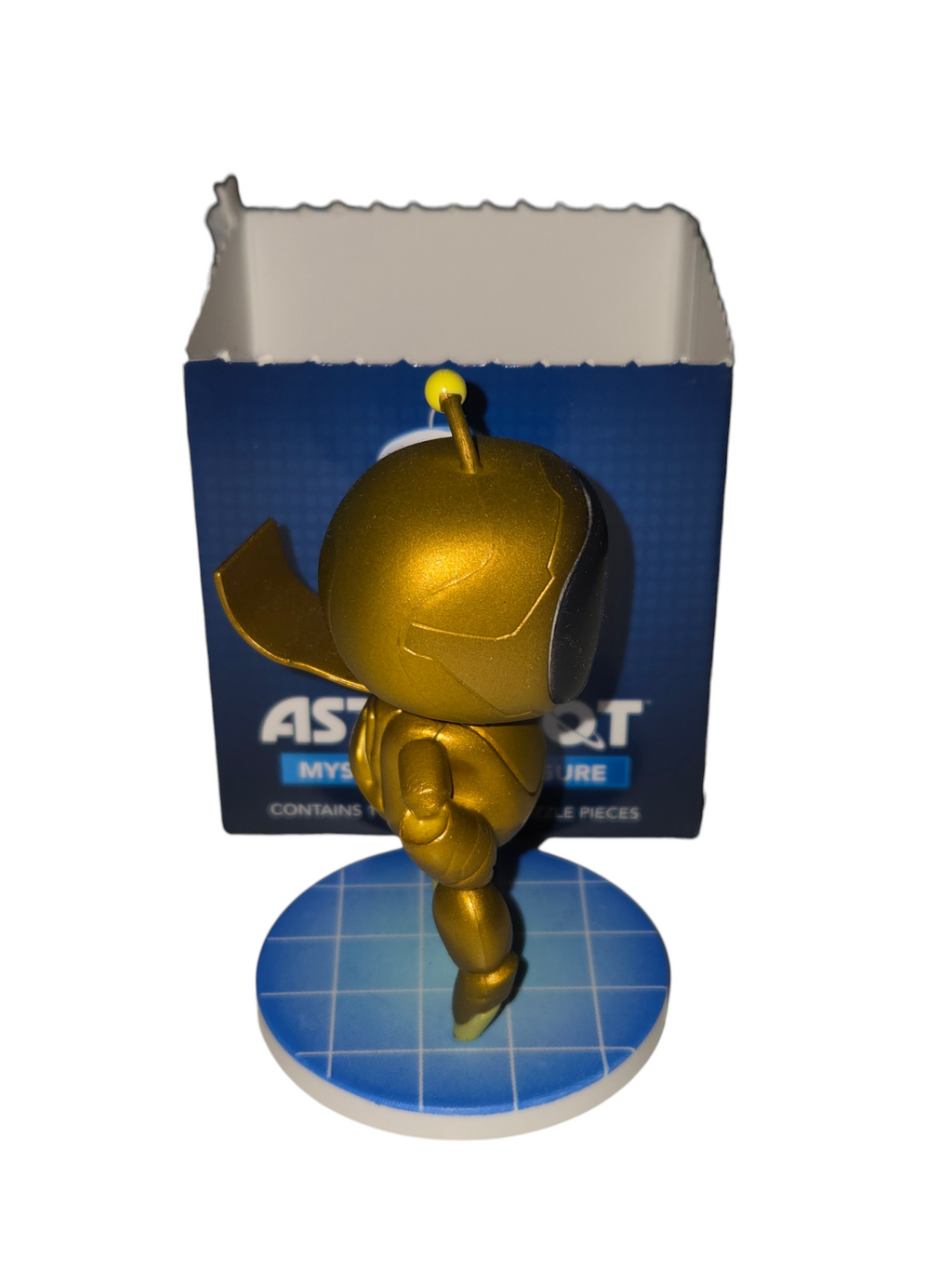 Opposite side of CultureFly gold Astro Bot chase figure showing cape and opened box