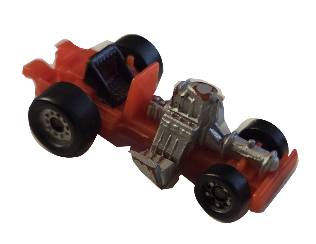 Preowned Galoob red racer chassis, incomplete on white background
