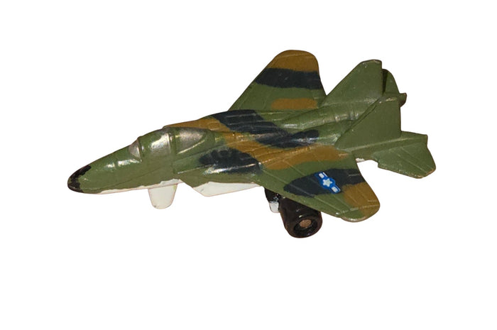Miniature camouflage twin-tail fighter jet side view showing paint chips