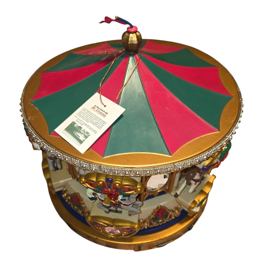 Red and green carousel canopy with surface wear and bent top flag