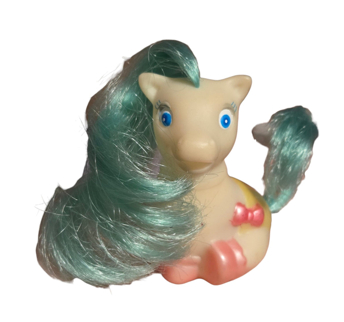Front of Tara Toy sitting baby pony with teal hair and pink hooves
