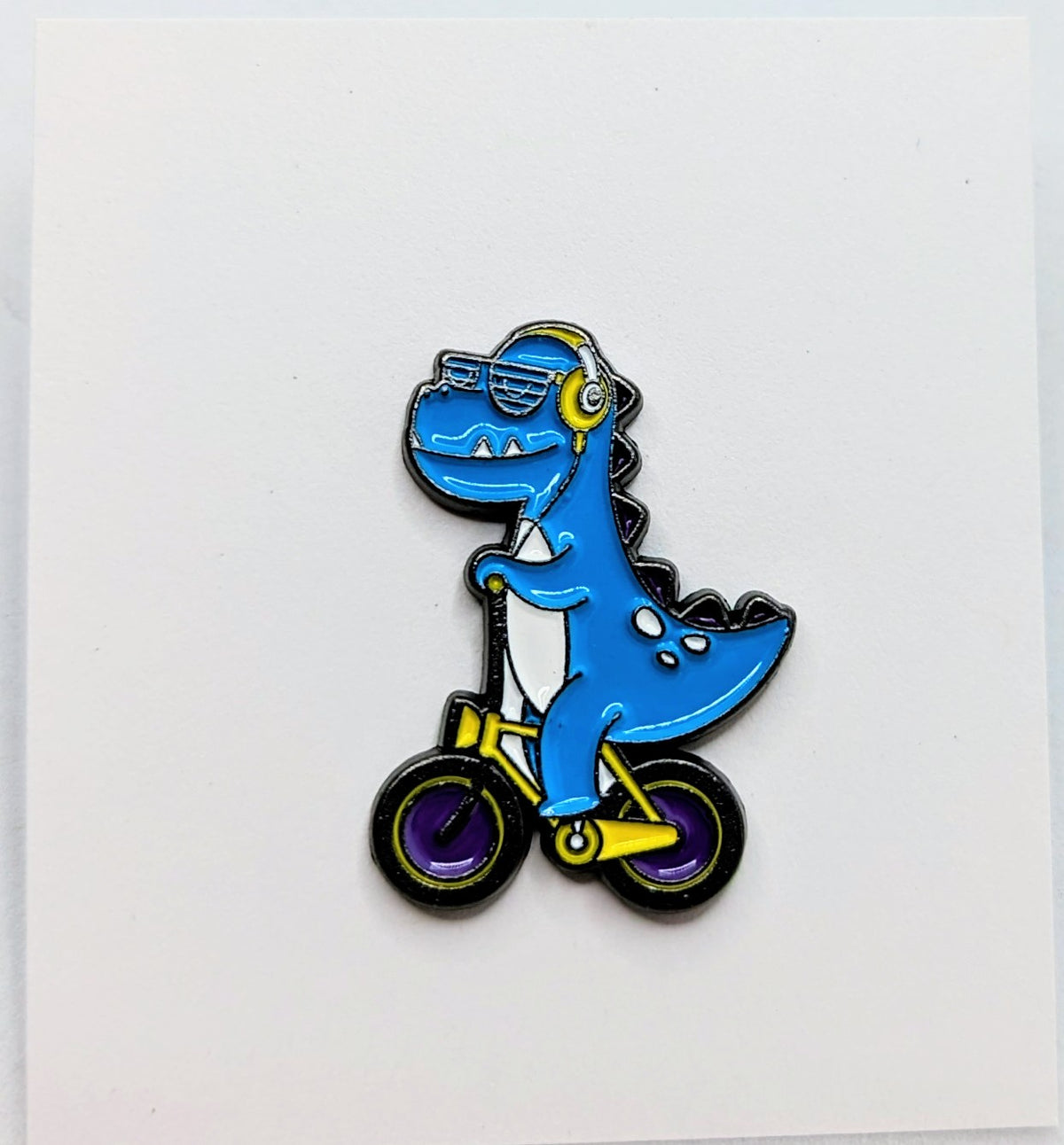 Blue T-Rex Tyrannosaurus Rex Dinosaur With Headphones Riding A Bike Enamel Pin
