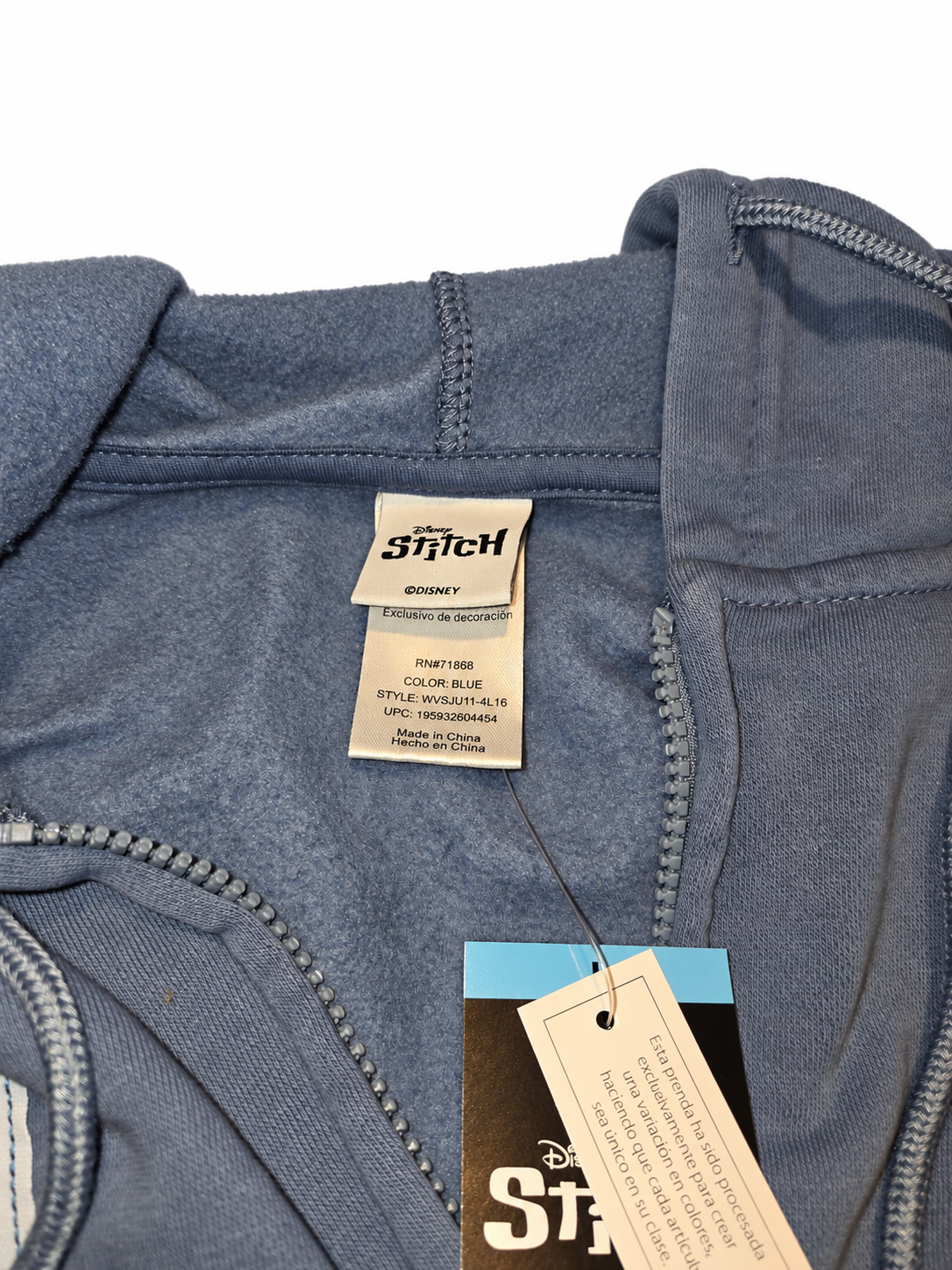 Disney Stitch neck label and attached retail tags on blue hoodie, white background