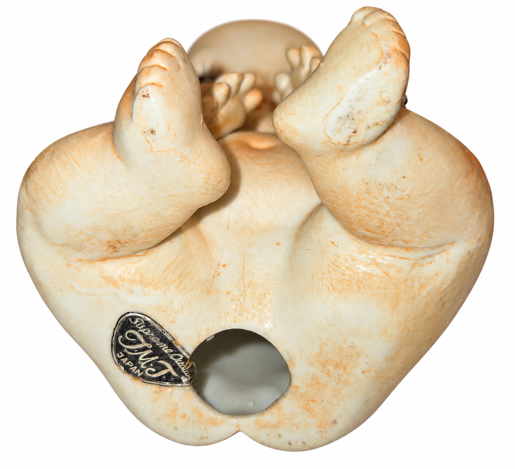 Kewpie figurine underside showing Supreme Quality Japan label and surface wear
