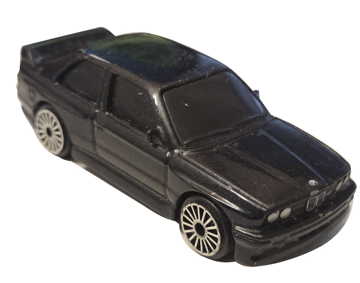 Pre-owned Maisto 1988 BMW M3 E30 black diecast car front-right view on white background showing original wear