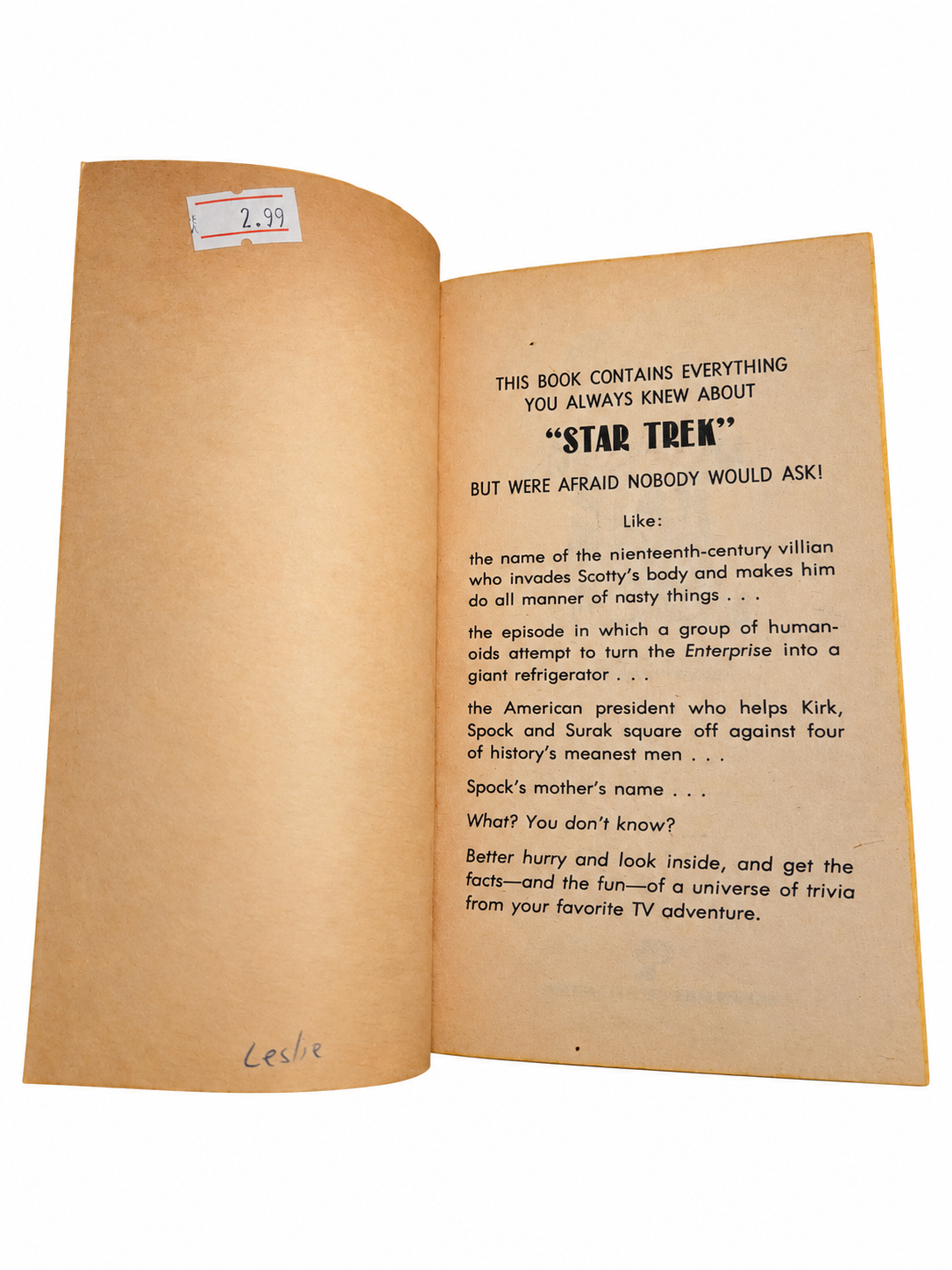 The Official Star Trek Trivia Book opening pages with fingers removed on white background