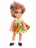 Vintage Skediddle-style clone doll front with floral dress and visible paint wear